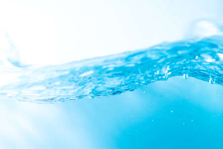 Water wave with bubble of air, on white background. Blue waterの写真素材