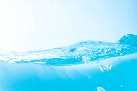 Water wave with bubble of air, on white background. Blue waterの写真素材