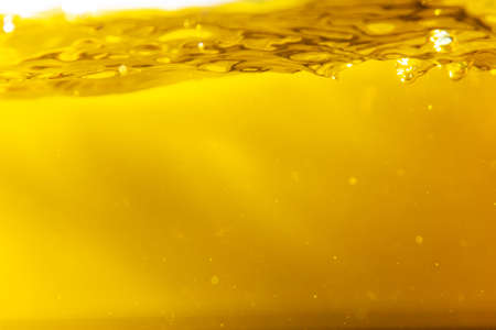 Water wave with bubble of air, on white background. Yellow waterの写真素材