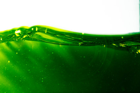 Water wave with bubble of air, on white background. Green waterの写真素材