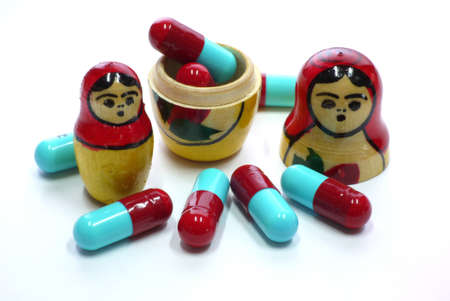 Russian Babushka nesting dolls and red blue capsules