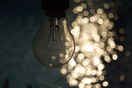 Light bulb on blue and bokeh background