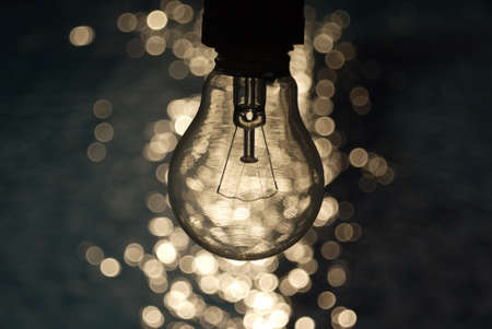 Light bulb on blue and bokeh backgroundの写真素材