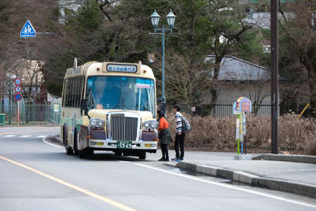 Yamanashi, Japan - Mar 19, 2016 : Unidentified people access to Retro sightseeing red line Bus to visit Kawaguchiko attractive locations at Kachi kachi ropeway bus stopのeditorial素材