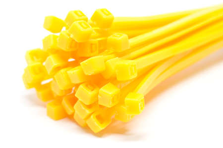 Cable tie in yellow isolated on white background Closeup