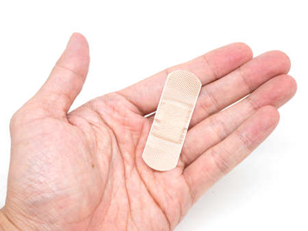 Adhesive Healing plaster putting on hand for first aid concept