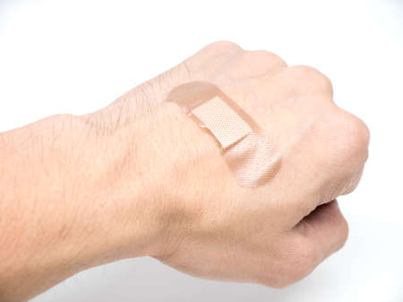 Adhesive Healing plaster putting on hand for first aid concept
