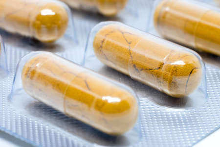 yellow herb pills transparent gelatin capsule in blister packの写真素材