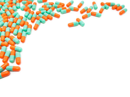 green orange color pills capsule on white background