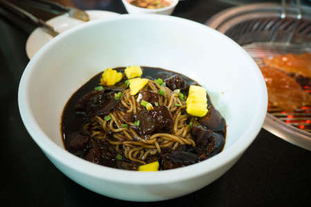 is a Korean Chinese noodle dish topped with a thick sauce made of chunjang(dark sweet bean sauce),...