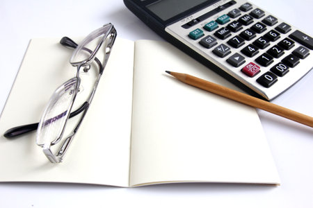 Calculator, notebook, eyeglass and pencil for calculateのeditorial素材