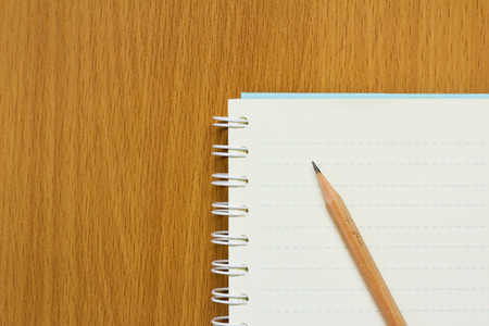 Pencil, book on wood table