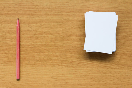 Pile of blank paper and pencil on wood table