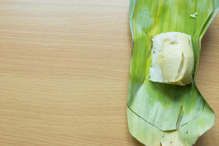 Traditional sticky rice and thai custard on banana leaf backgroundの写真素材