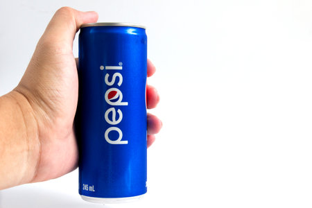 Bangkok, Thailand - October 30, 2016:Pepsi cola hold by male hand on white background. Pepsi is a...