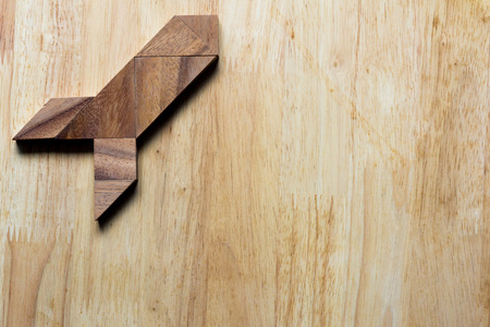 Wooden tangram puzzle in rocket shape, start up or discovery conceptの写真素材