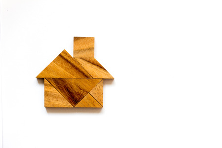 Wooden tangram as home shape on white backgroundの写真素材