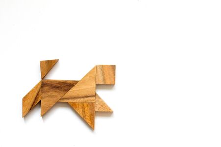 Wooden tangram as running dog shape on white backgroundの写真素材