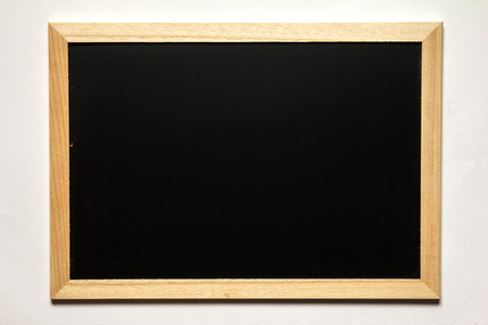 Blank black board with wood frame on white backgroundの写真素材