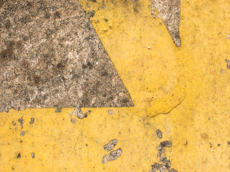 Grunge yellow line cross as corner on stained concrete backgroundの写真素材