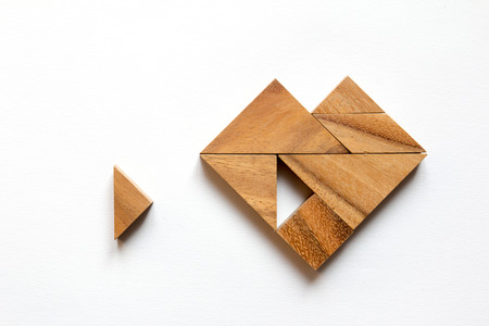 Tangram puzzle wait for fulfill to heart shape on white backgroundの写真素材