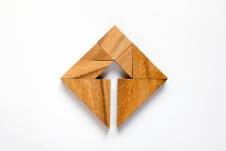 Tangram puzzle as arrow in square shape on white background (Concept for business direction and decision)の写真素材