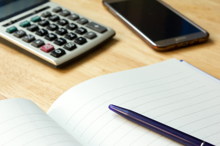 Note book with pen,calculator, smart phoneの写真素材