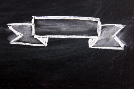 Blank ribbon draw by white chalk on black board backgroundの写真素材