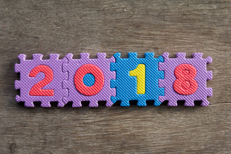 Toy alphabet connect to wording 2018 on wooden background (Concept happy new year)の写真素材