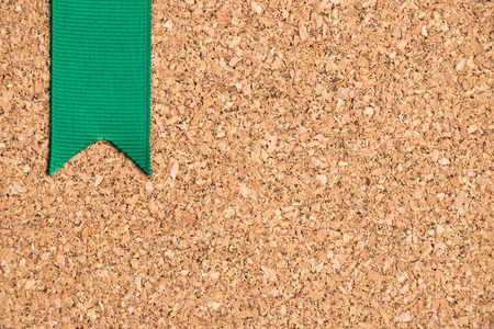 Green ribbon on cork board texture backgroundの写真素材