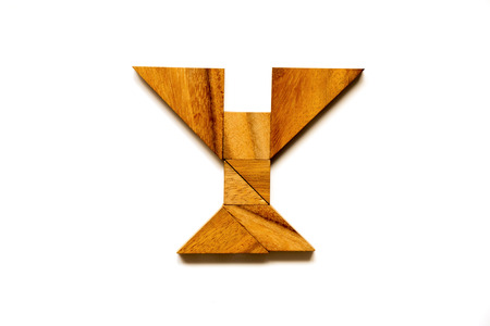 Wooden tangram puzzle as English alphabet letter "Y" shape on white backgroundの写真素材