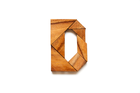 Wooden tangram puzzle as English alphabet letter "D" shape on white backgroundの写真素材