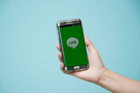 Bangkok, Thailand July 8, 2017 : Woman held android smart phone Samsung galaxy S7 Edge with line...
