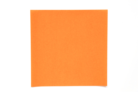 Orange color paper sheet on white background used for decoration or design elementの写真素材