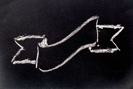 White chalk drawing as reward ribbon shape on black board backgroundの写真素材