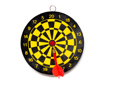 Yellow and black color dartboard with number and dart on white backgroundの写真素材