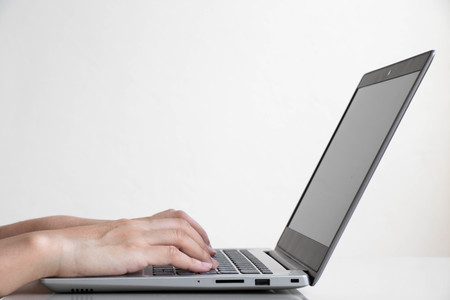 Business man use the computer notebook for working with white wall background の写真素材