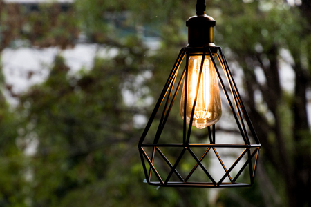 Yellow lamp hanging with green background