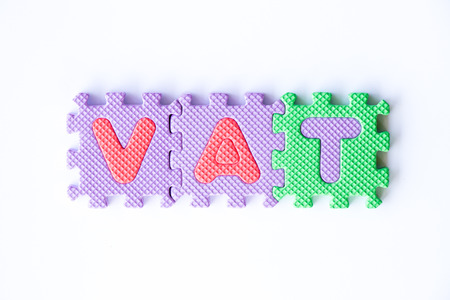 Color toy foam alphabet in word VAT (Abberviation of Value added tax) on white backgroundの写真素材