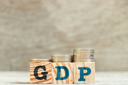 Block in word GDP (Gross domestic product) with coin in increase trend on wood backgroundの写真素材