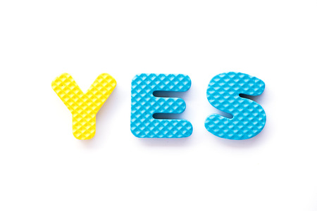 Color toy foam alphabet in word yes on white backgroundの写真素材