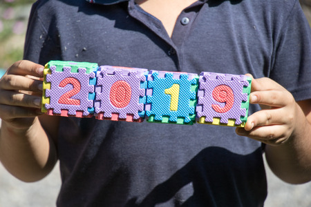 Background of child hold toy alphabet block in word 2019の写真素材