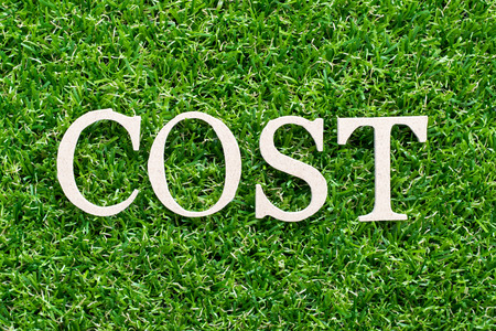 Wood alphabet in word cost on artificial green grass backgroundの写真素材