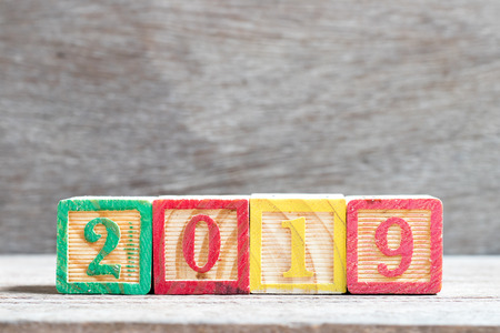 Color letter block in word 2019 on wood background (Concept for happy new year)