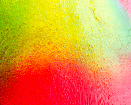 Abstract red, green and yellow painting on concrete background