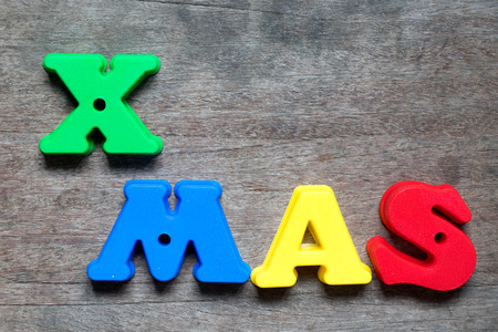 Color alphabet in word Xmas on wood background (Concept for celebrate christmas)の写真素材