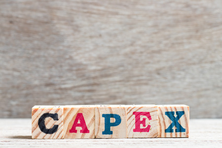 Letter block in word capex (abbreviation of capital expenditure) on wood backgroundの写真素材
