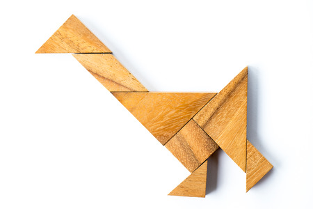 Wood tangram puzzle in walking swan or duck shape on white backgroundの写真素材
