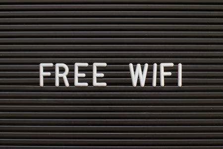 Black color felt letter board with white alphabet in word free wifi backgroundの写真素材