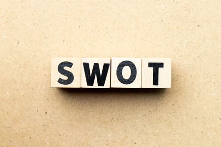 Alphabet letter block in word swot (abbreviation of strength, weakness, opportunities, threats) on wood backgroundの写真素材